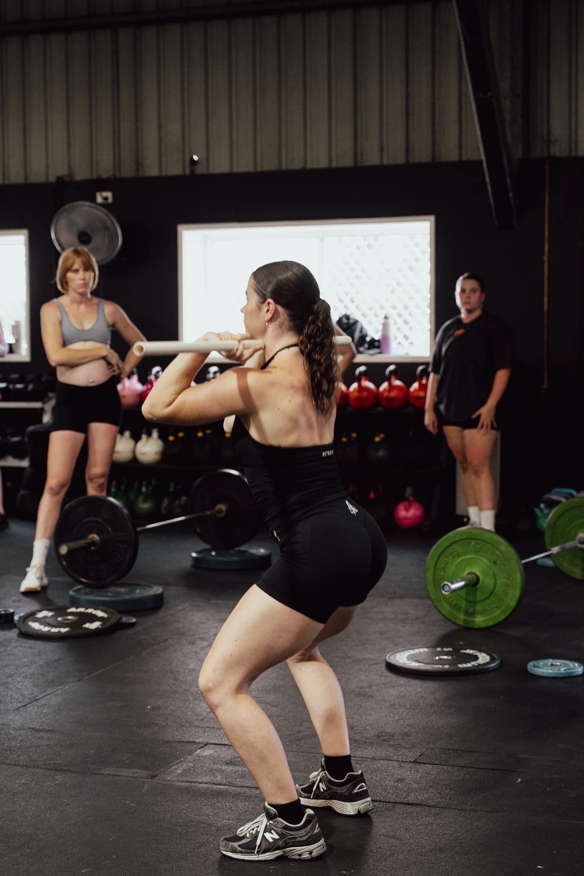 A WITHIN member training with a barbell during a group fitness session