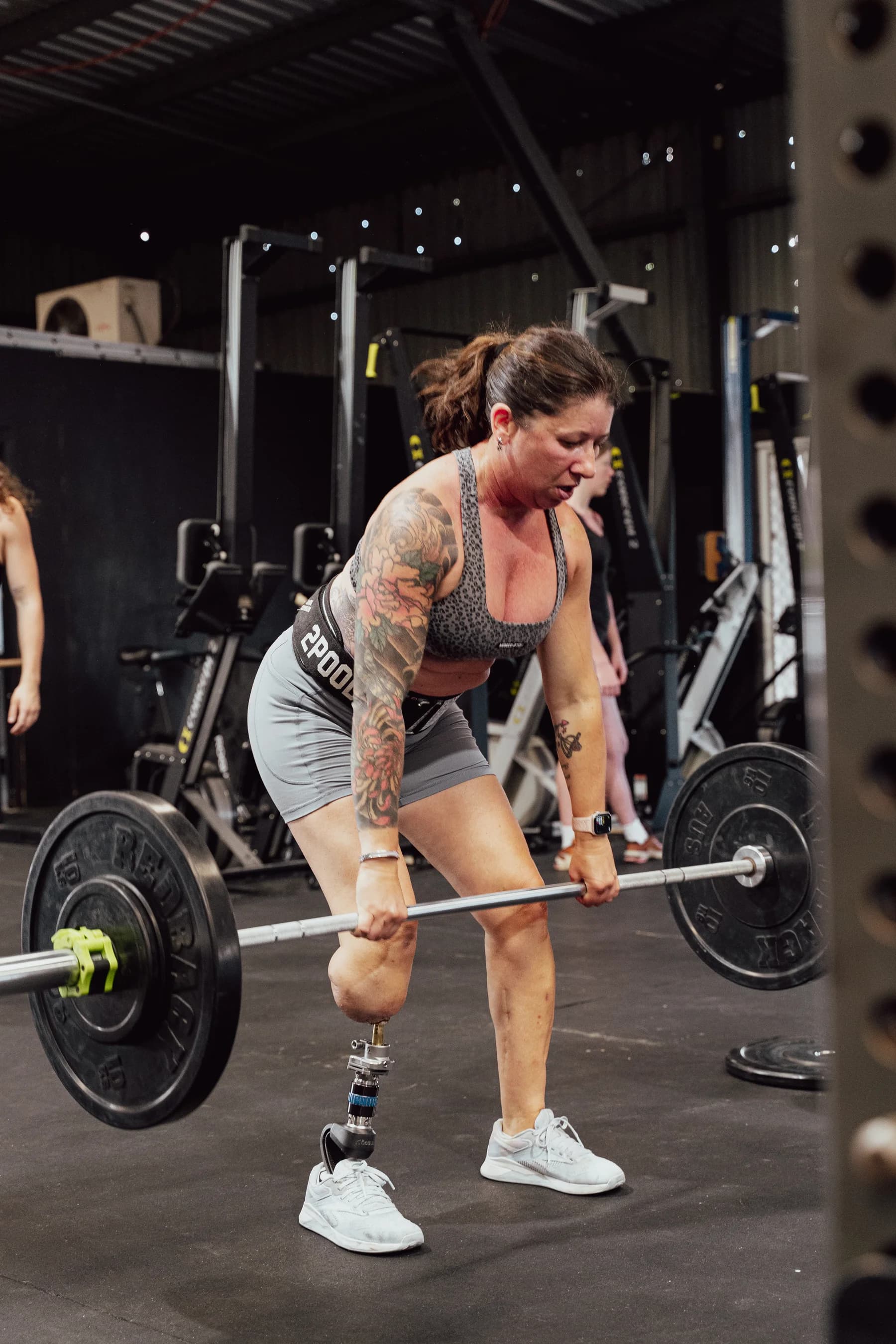 A WITHIN member lifting a barbell during a Functional Fitness session